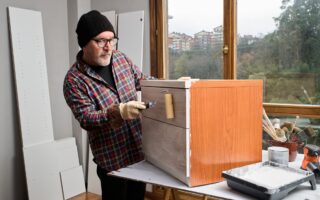 Mature man painting furniture