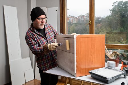 Mature man painting furniture