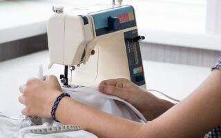 woman sews on the sewing machine